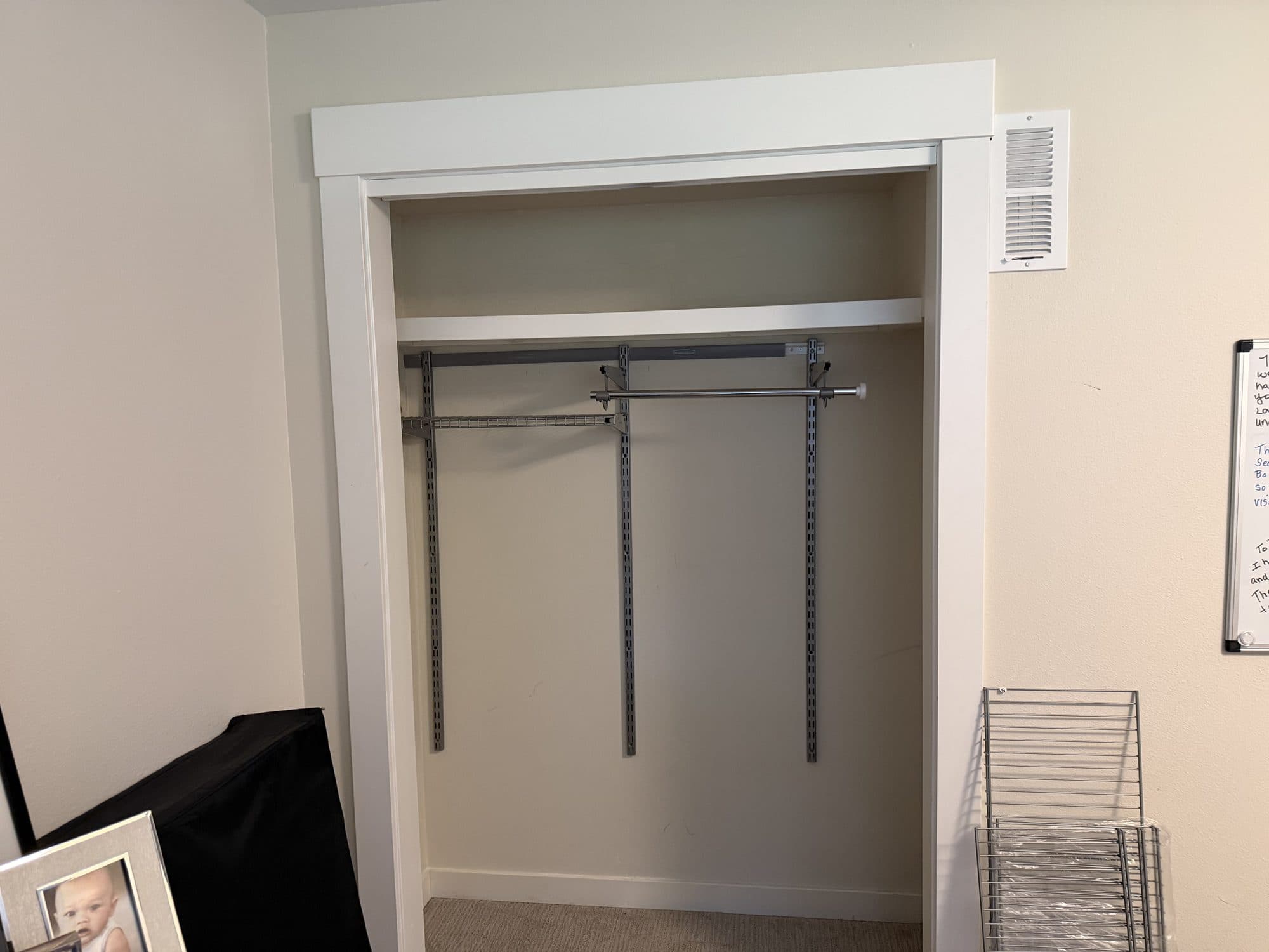 A standard bedroom closet with hanging rods