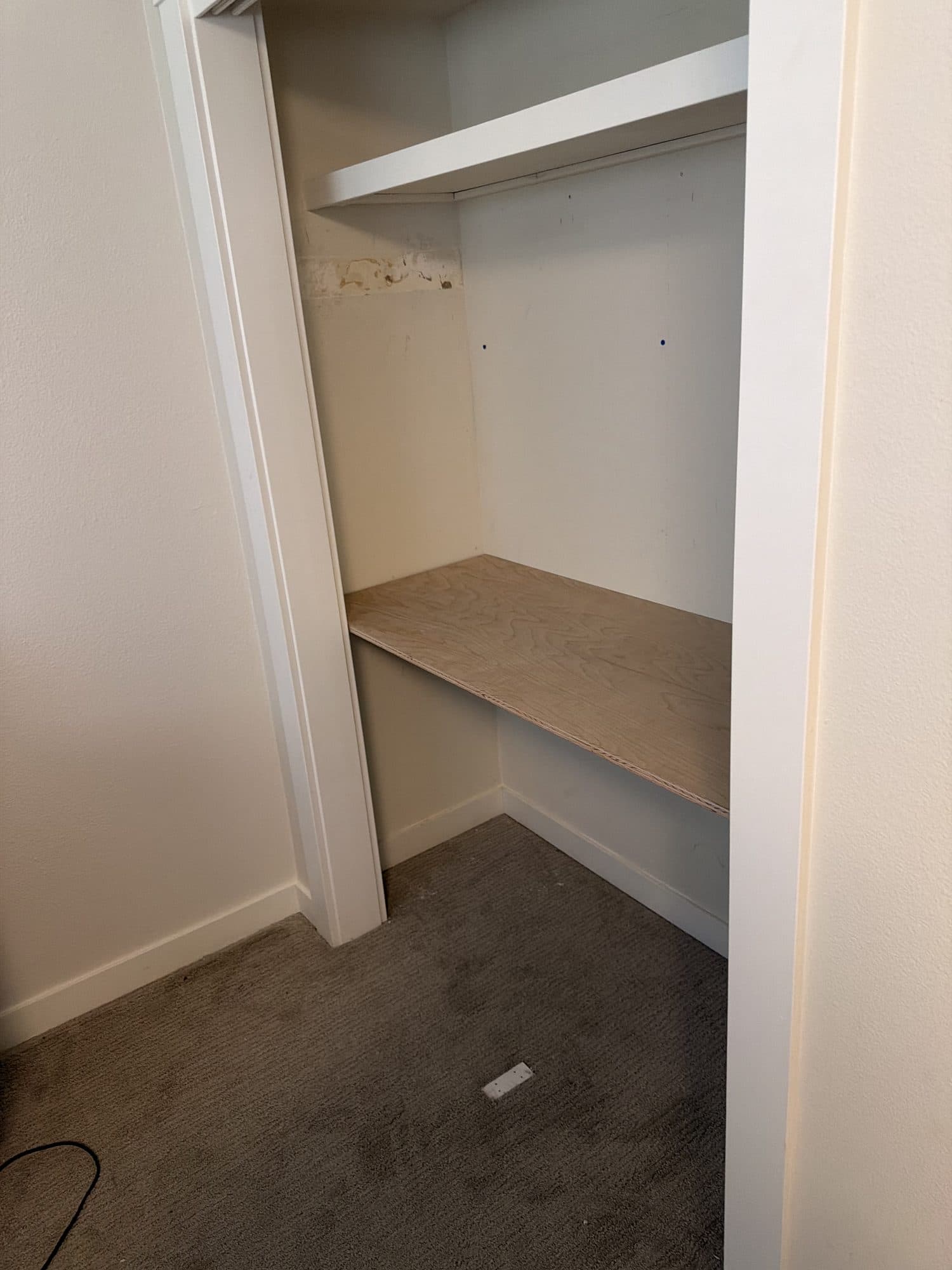 The plywood desktop spanning the closet