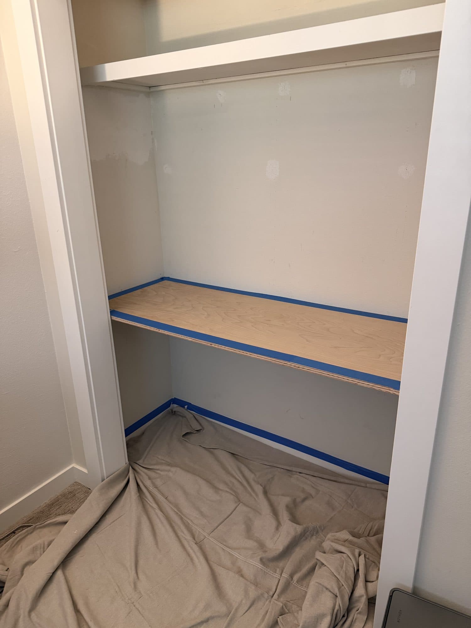 The desktop and baseboards taped off with blue tape