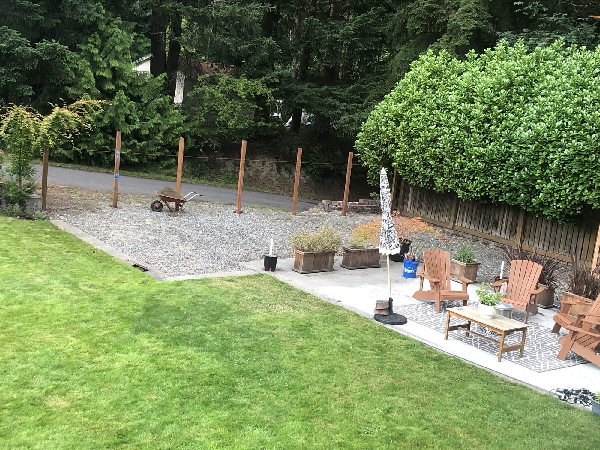 Posts set along the edge of the yard before boards go on
