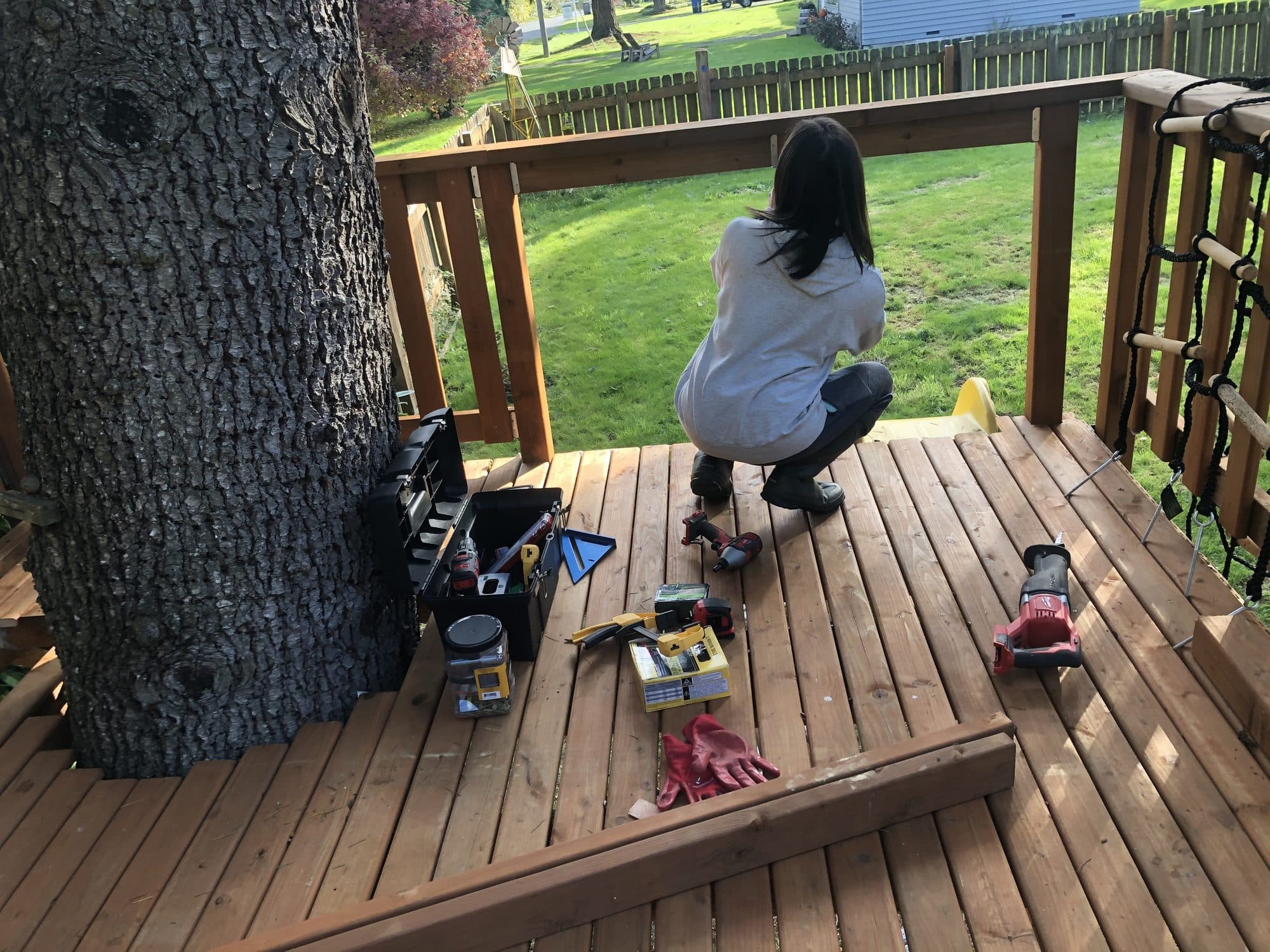 Floor boards being laid around the trunk