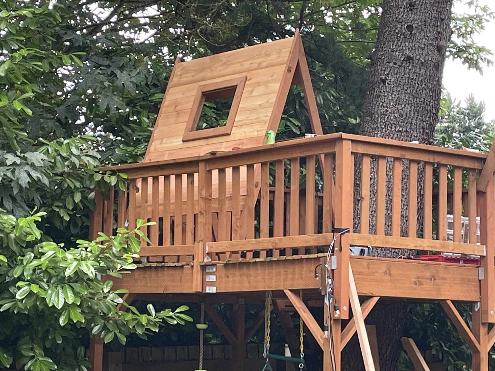The finished tree house structure with window and railings