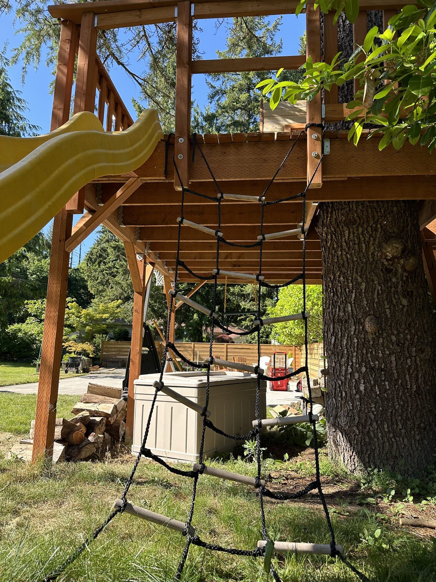 Cargo net and slide attached to the tree house
